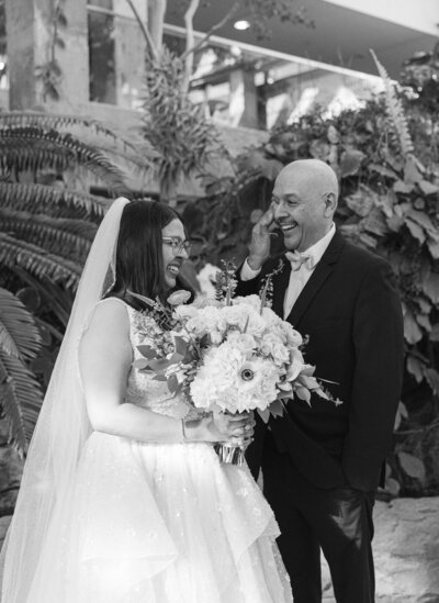 Emotional first look between bride and her dad inside the greenhouse at the Denver Botanic Gardens  