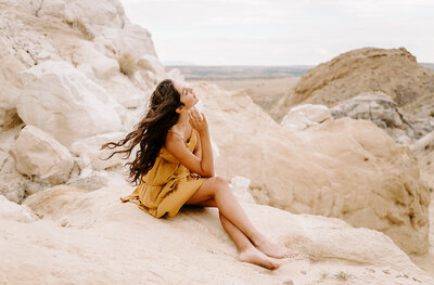 woman sitting on rock