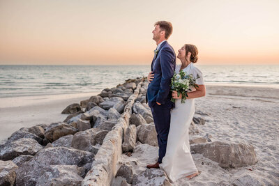 The couple’s St. Pete Beach elopement is beautifully captured with a vibrant sunset, highlighting their special day.