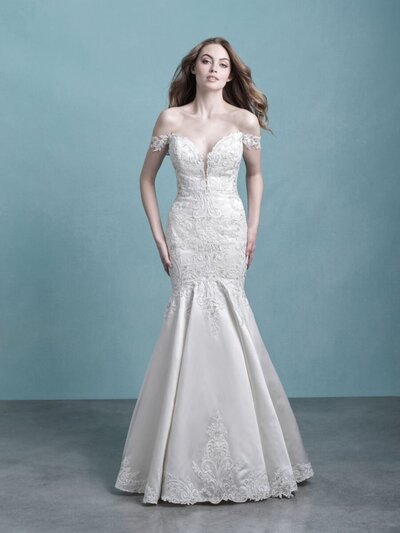 Iridescent beadwork illuminates the lace appliques along the bodice and hemline of this A-line sleeveless gown.