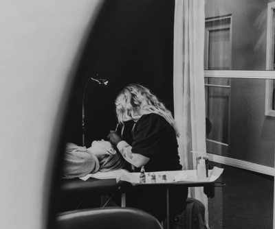 Artist applying microblade and nano brow treatment at Lavender & Ink Studios