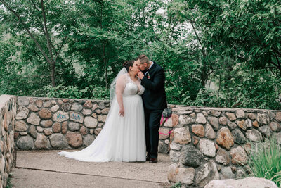 Bride holding husband's arm on a walking path at the U of S.