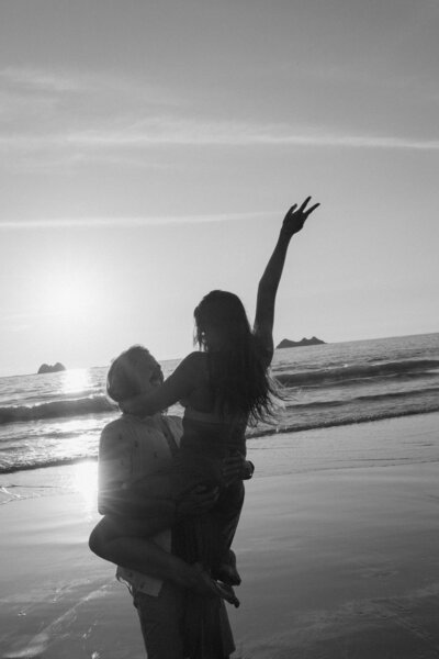A playful couple having fun on the beach in Uvita, Costa Rica.