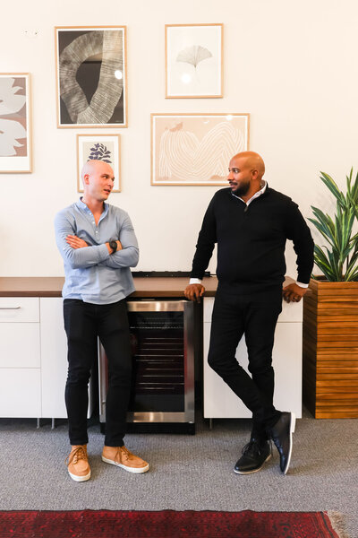 2 Firefly Team members standing and having a chat in the break room