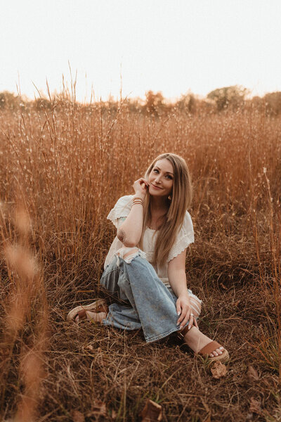 Laura Vitale sitting in a field during a peaceful outdoor session in Pennsylvania