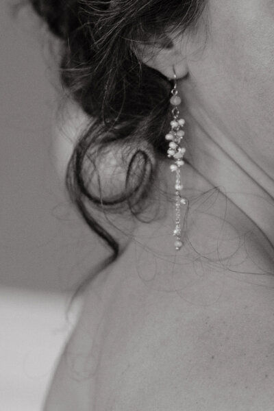 detail photo of a bride's hair and earring on wedding day photographed by wedding photographer sarah mismash in seattle, washington