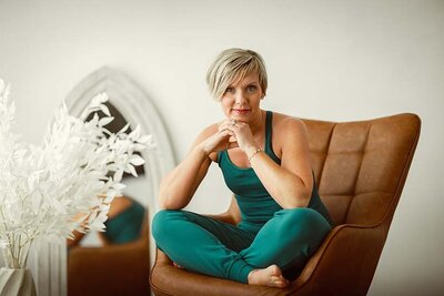 natalie clark in a brown chair in yoga attire