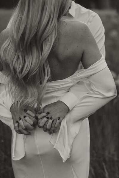 black and white photo, bride and groom holding hands