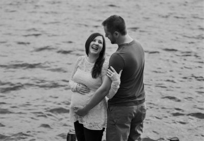 Photo of expecting parents by the water | Maternity Session