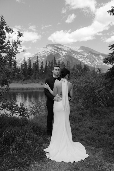 Bride and groom share a candid moment after pouring champagne at their wedding reception