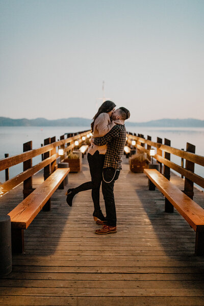 couple kissing on a pier