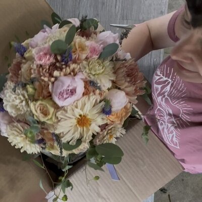Bride and groom looking at each other bride holding bright bridal bouquet