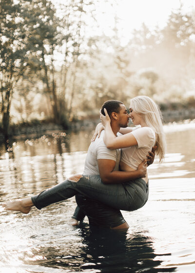 Couple plays in the water during this fun couple's photoshoot in Wisconsin.