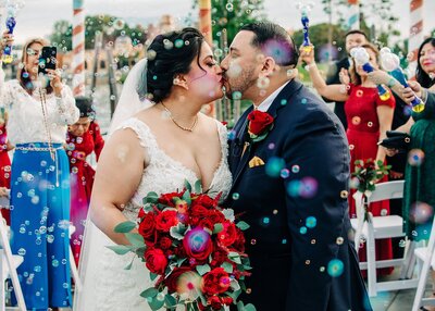 Newlywed couple kissing  during bubble send off at Disney Italy Pavilion at Epcot