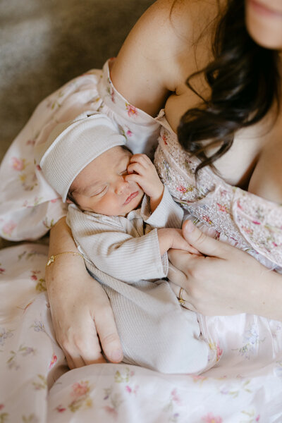 Close up photo of mom and dad's faces close to their newborn baby's face