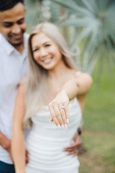 newly engaged girl showing ring to camera