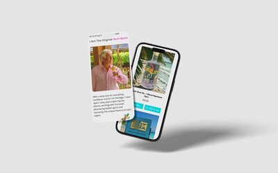 Two floating smartphones showing a Caribbean rum website with one screen featuring an older man in a pink shirt holding a drink and the other showing a bottle of rum on a beach.