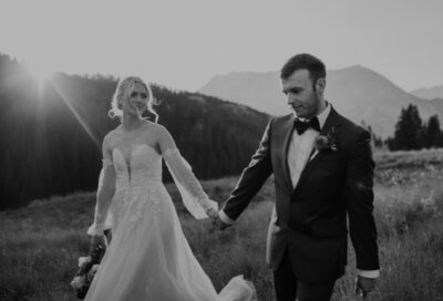 Bride and groom hold hands in Telluride