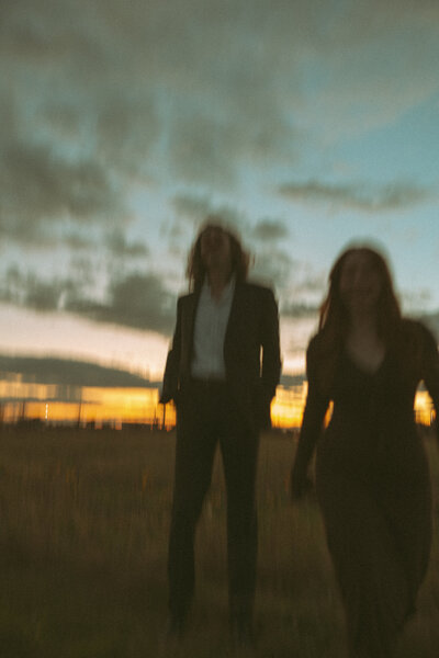 blurry editorial of couple in a field at sunset, editorial grand rapids wedding photographer