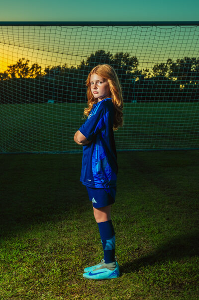 Soccer player posing with goal