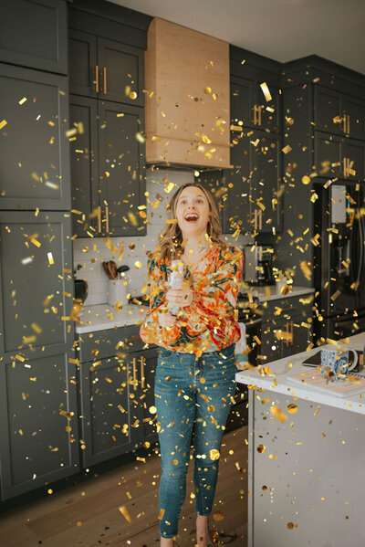 woman smiling standing in confetti