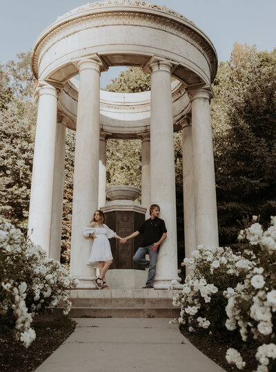 Couples photo at Memory Grove Park in Salt Lake City, Utah. Couple holding hands next to old column structure