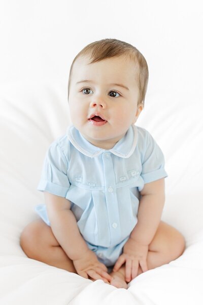 six month old boy in Feltman Brothers blue outfit for studio milestone photo in kinston nc