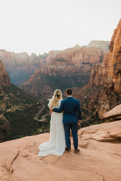 bride and groom on mountain top