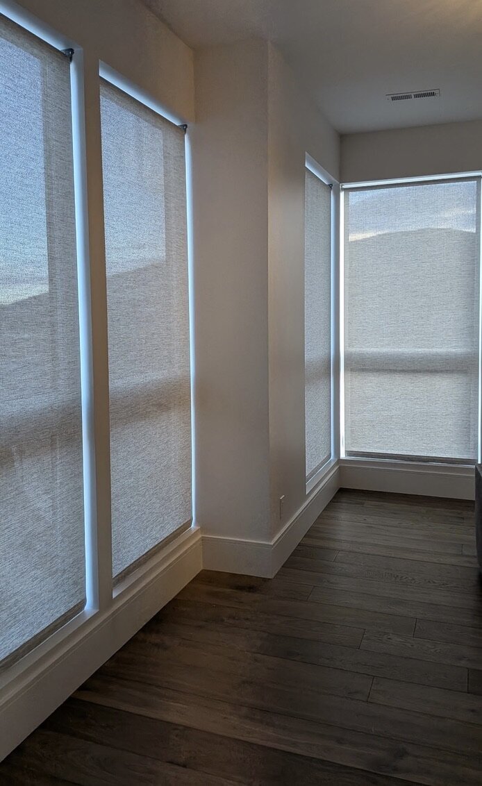 Solar shades on tall corner windows in a Park City, Utah live/work space