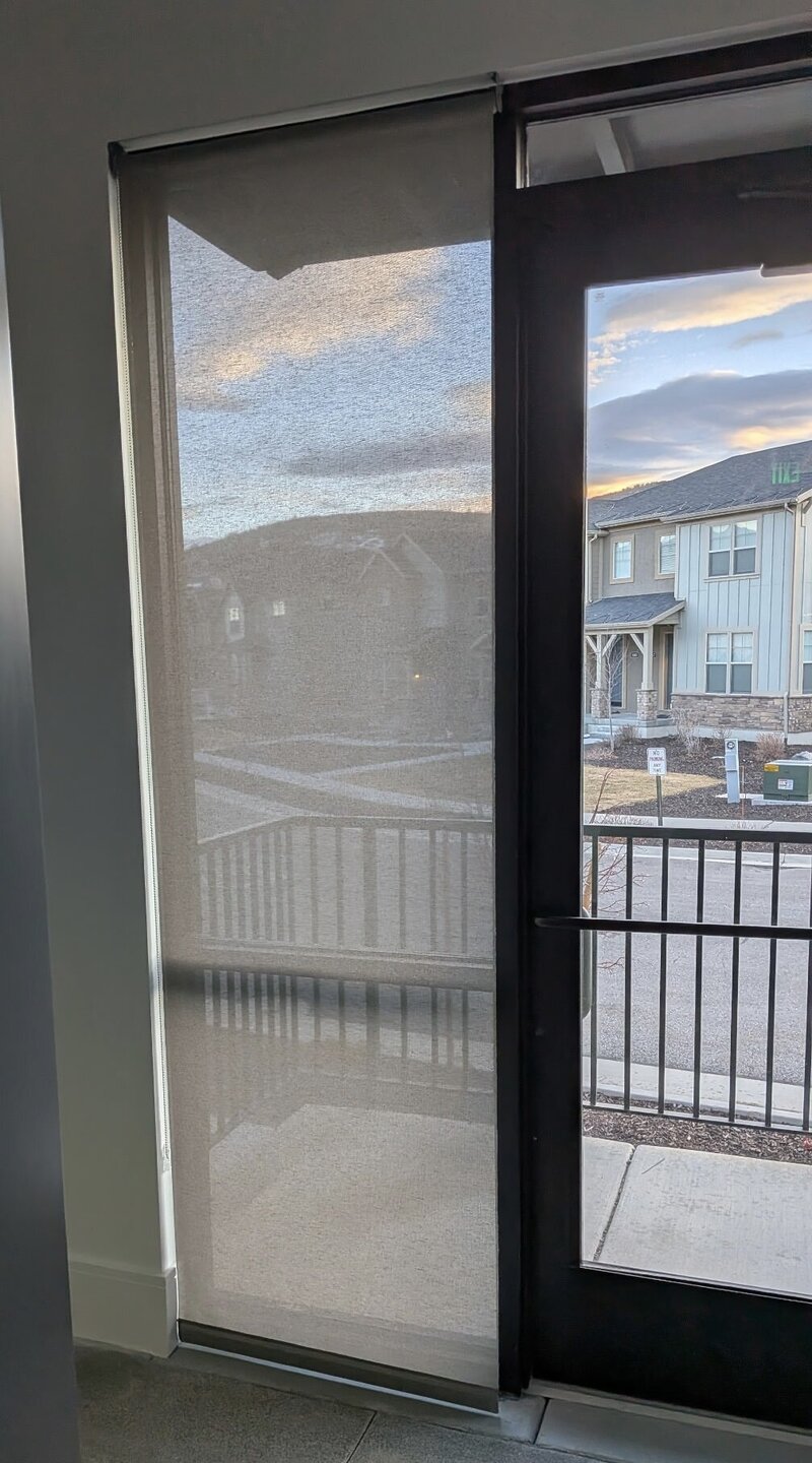 Solar shade on a commercial entry door with a balcony view in Park City, Utah