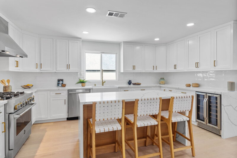 White upper cabinets and waterfall island edge