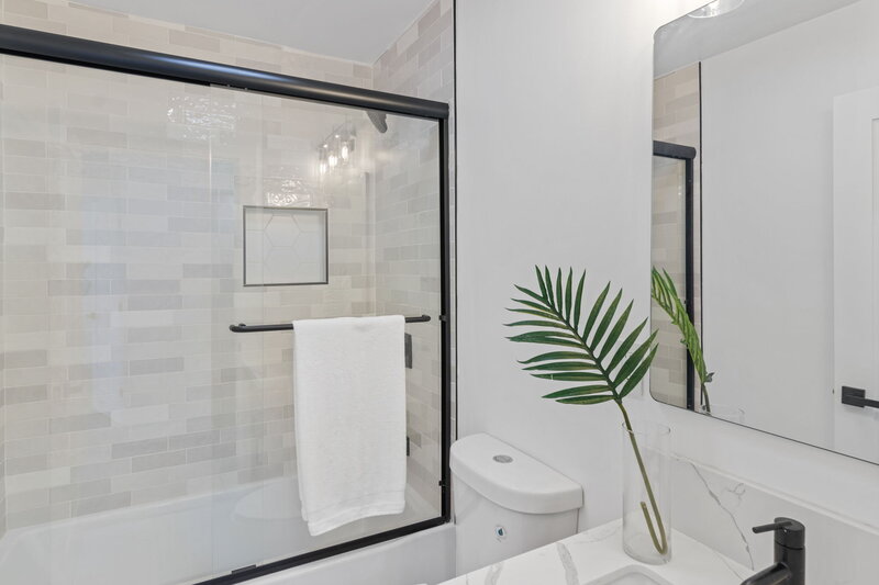 Glass shower enclosure with open towel bar