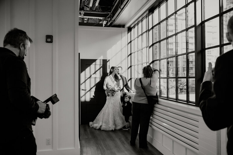 photographer and videographers capturing a bride and groom