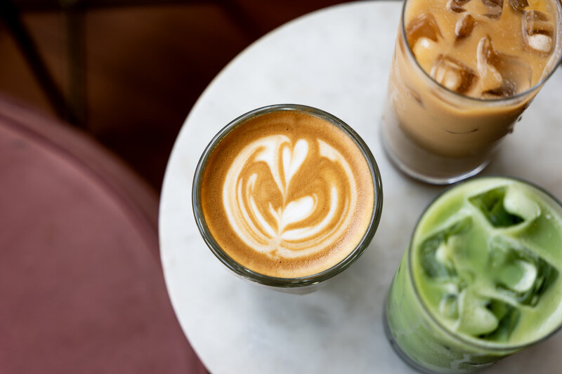 Overhead view of craft coffee, matcha, and iced latte drinks from Grain Artisan Bakery’s gluten-free café in Snohomish, WA.