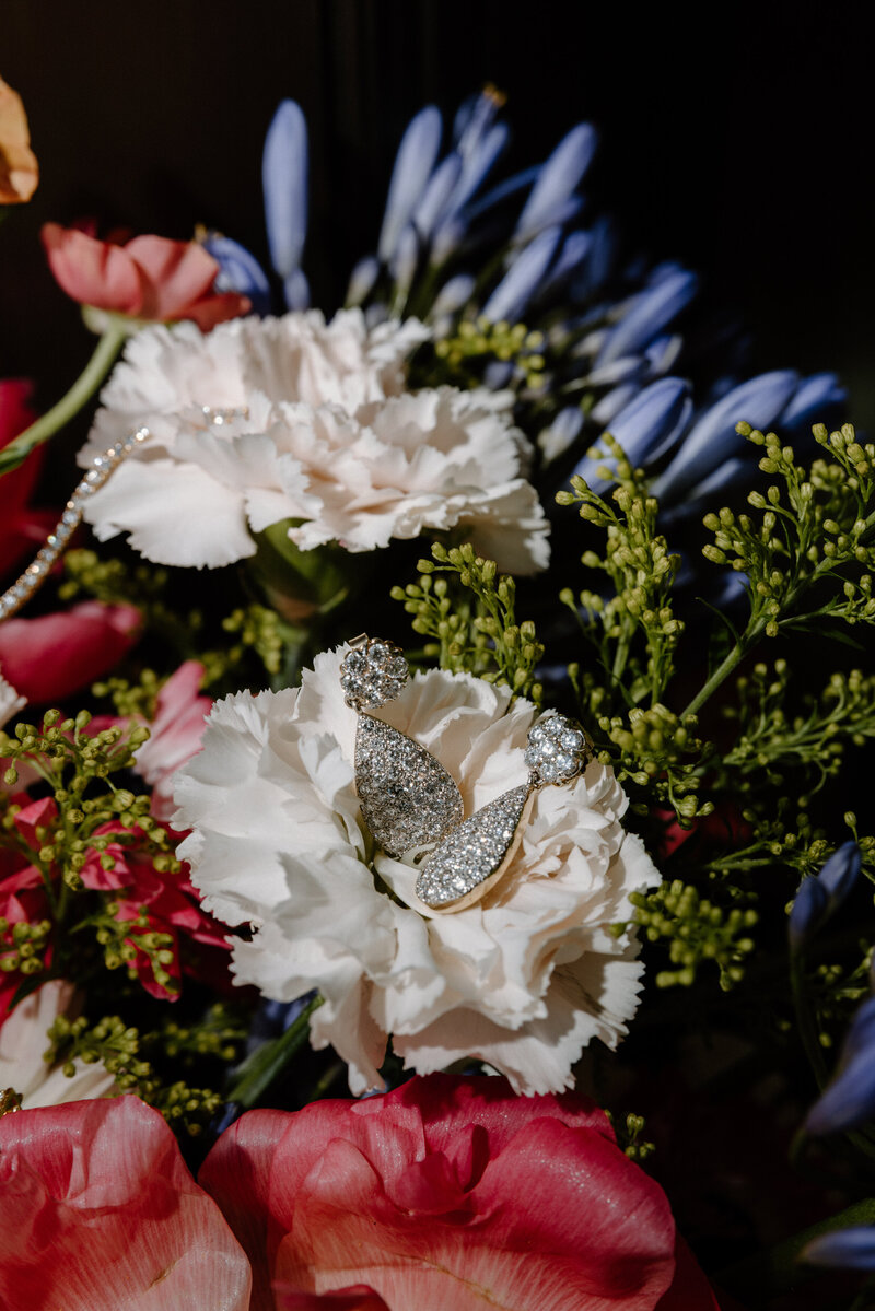Earrings laid in the middle of a flower 