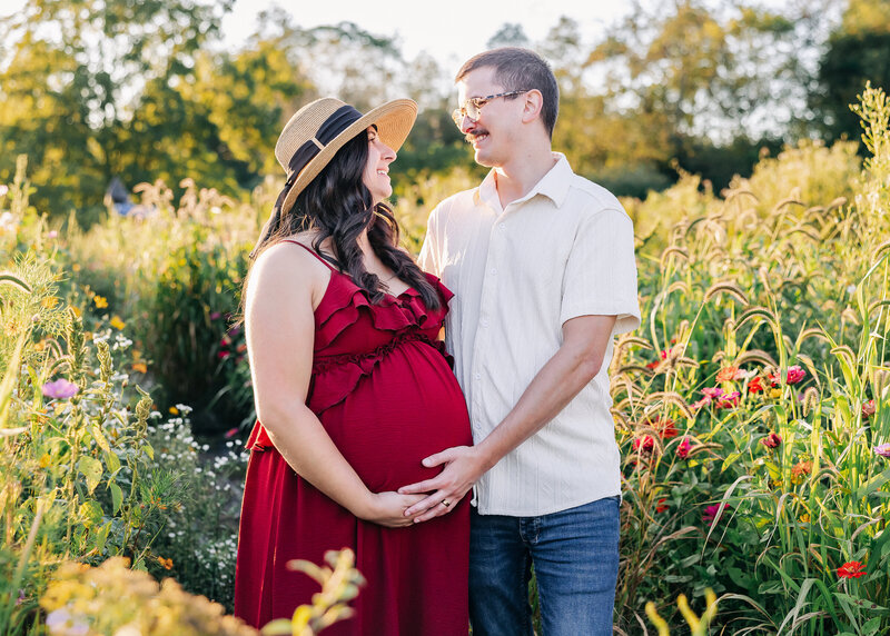 Lifestyle maternity photo at a sunflower field in New Jersey.