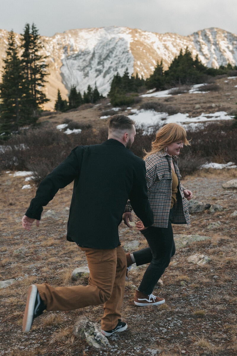 A fun, candid engagement session in the Colorado mountains on Loveland Pass during fall.