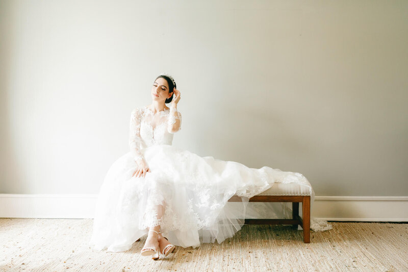 bridal portrait getting ready of bride sitting by the window
