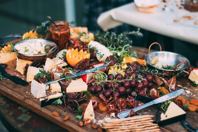 Spread of cheeses, fruits, jams and crackers