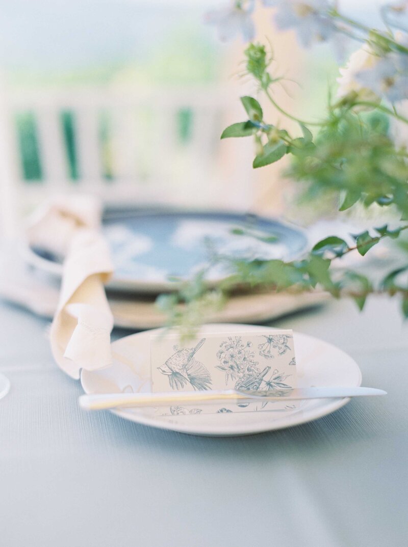 blue and white tableware on light blue linen at woodmark hotel wedding