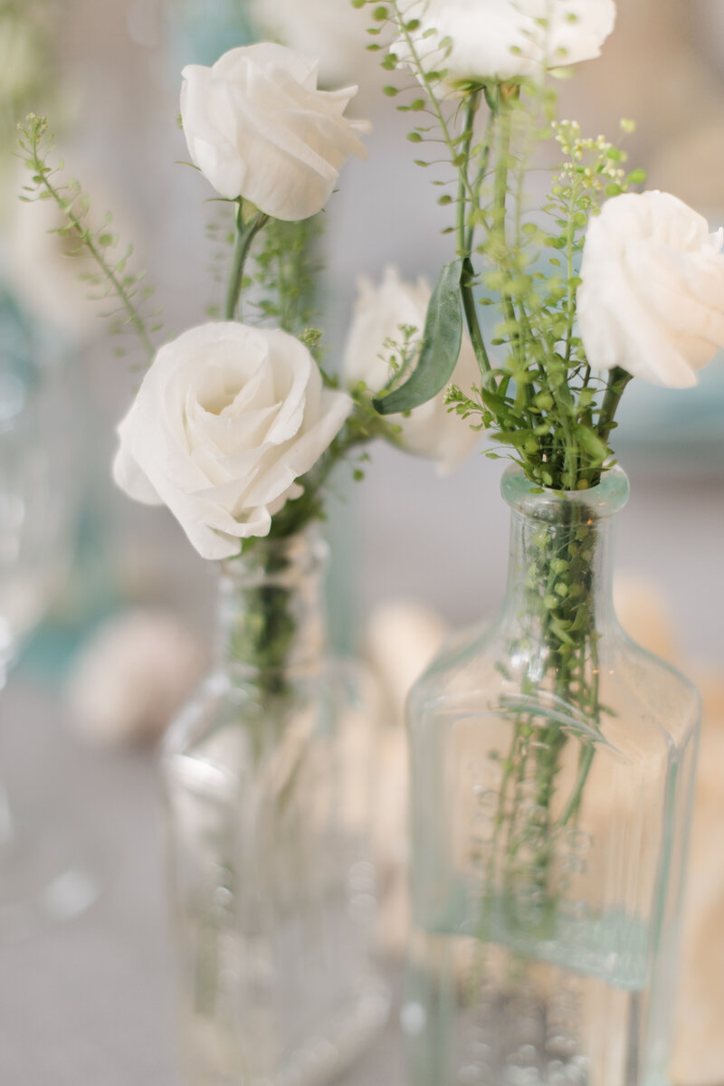 Bud vases with white flower stems