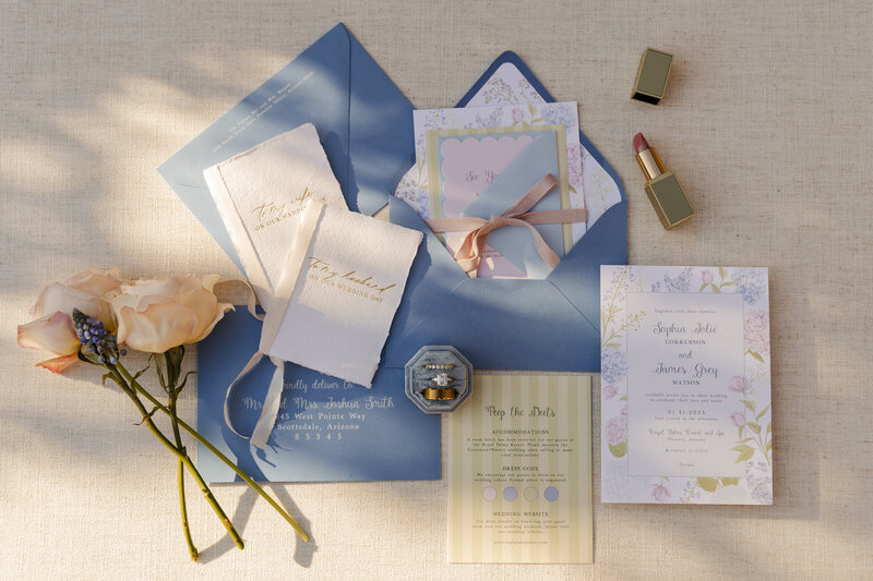 flatlay of wedding invitations and rings at wedding in arizona
