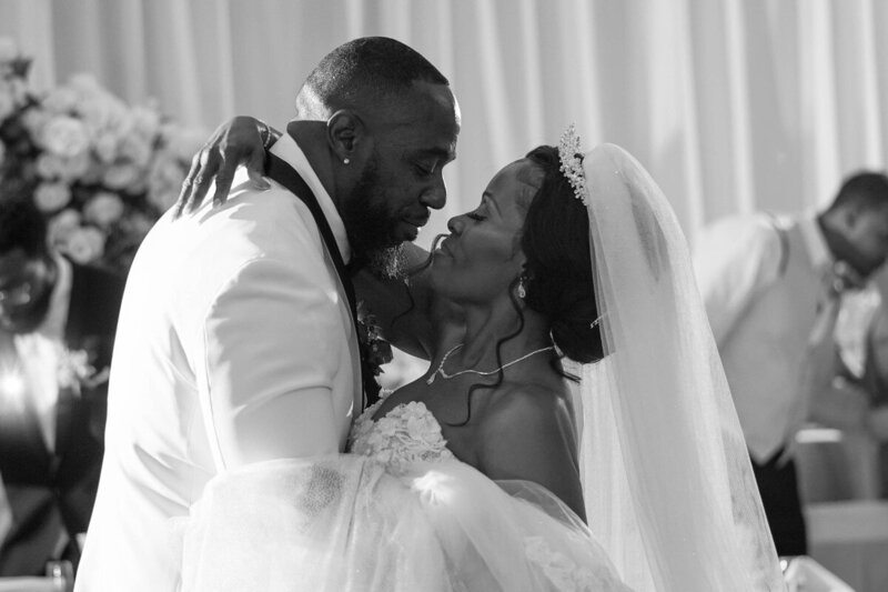 Black and white photo of bride and groom's emotional first dance at their wedding reception