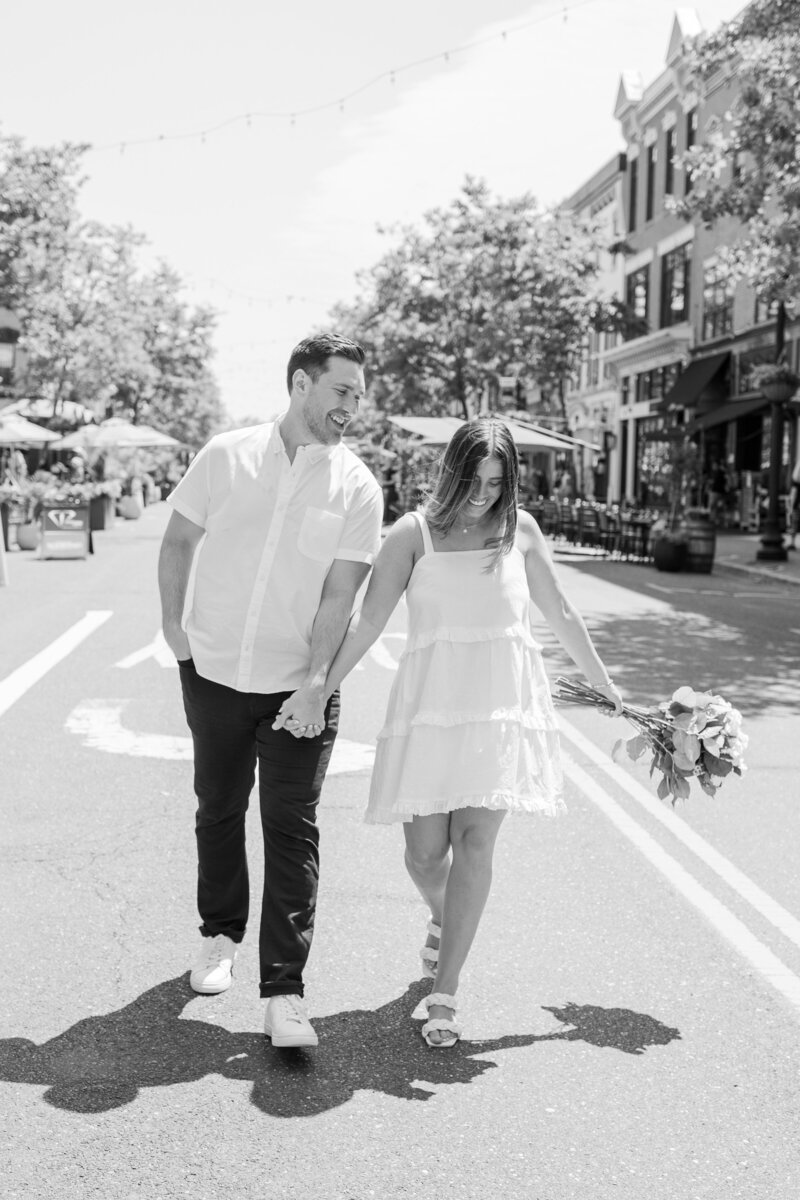 engaged couple walking down broad street red bank