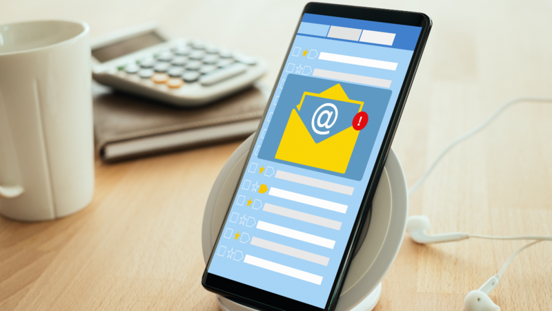 A mobile phone showing an email graphic sits on a desk. Learn how to create a winning email marketing strategy with your femtech startup, from Marketing Strategist & Copywriter