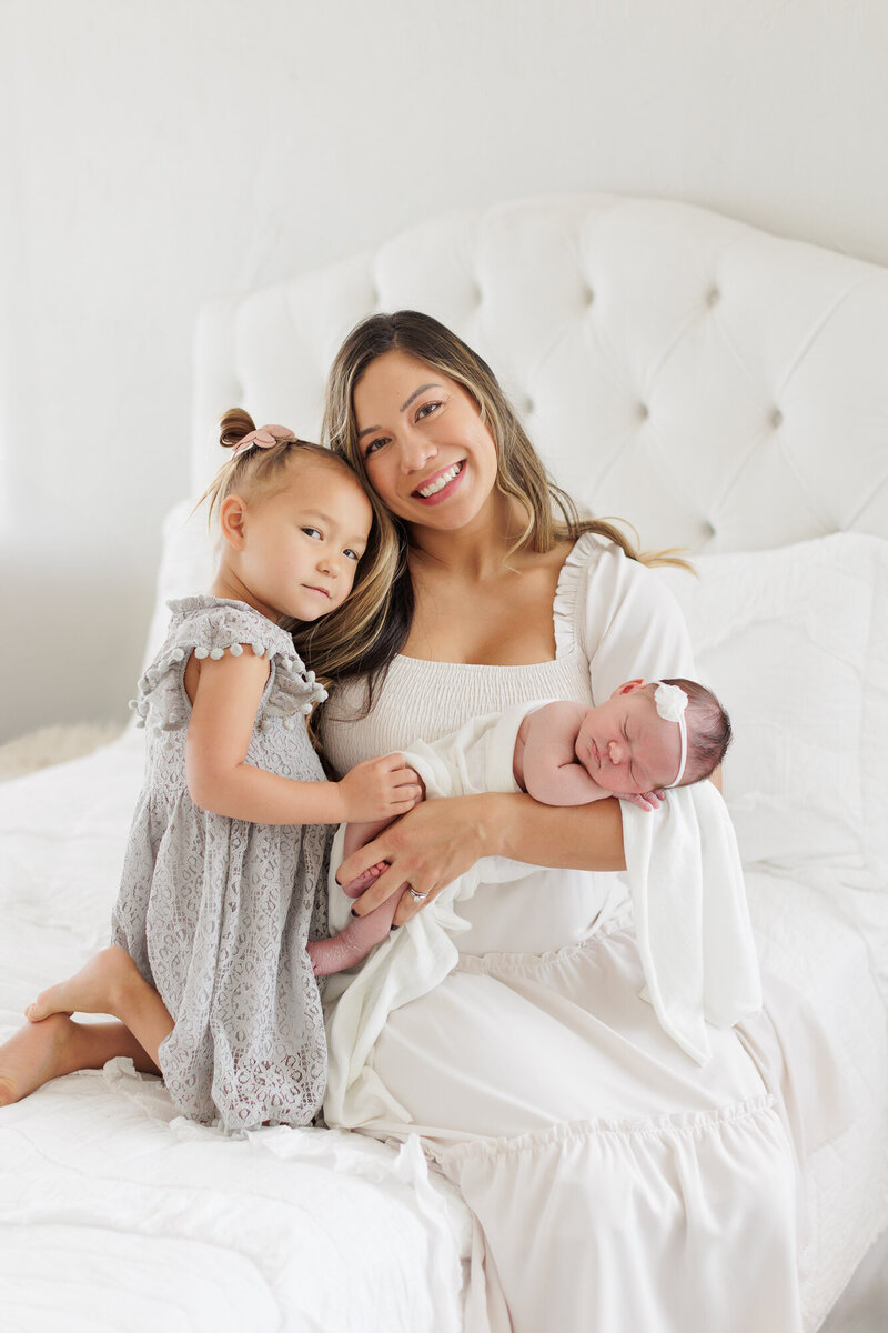 Mom, daughter and newborn baby in Boise photography studio.