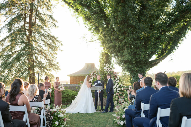 Classic and romantic wedding ceremony under ivy-covered tree at Hamilton Farm Golf Club in New Jersey