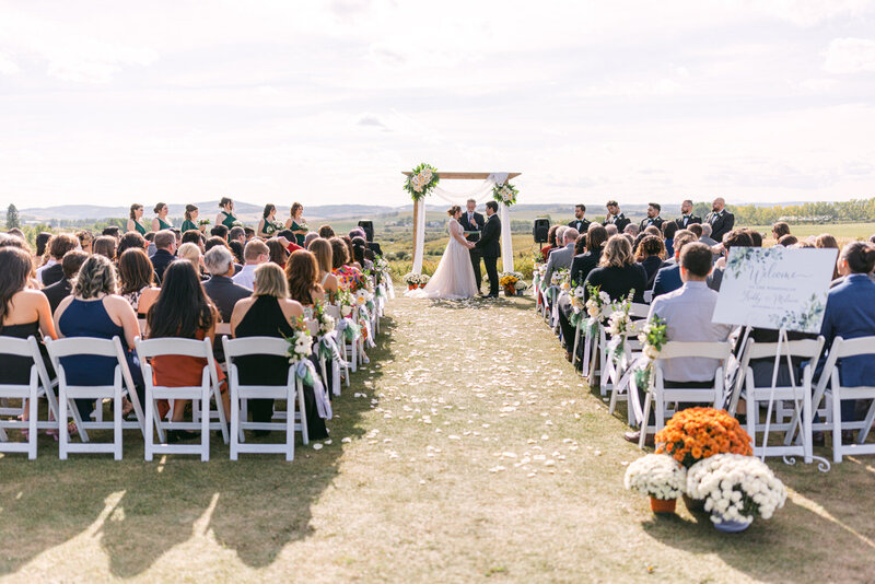 This beautiful photograph captures a wedding ceremony at Sirocco Golf Club, highlighting the stunning views and elegant atmosphere of this exceptional venue.