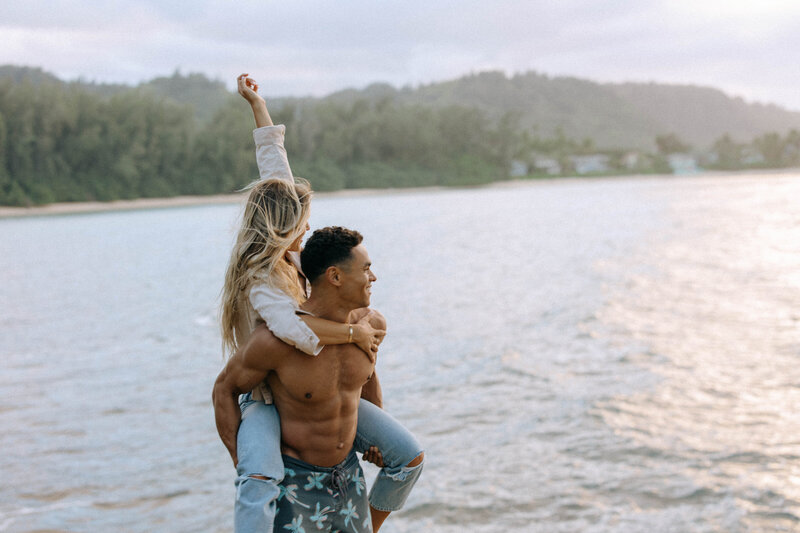 Piggy back ride couples session by the ocean carefree