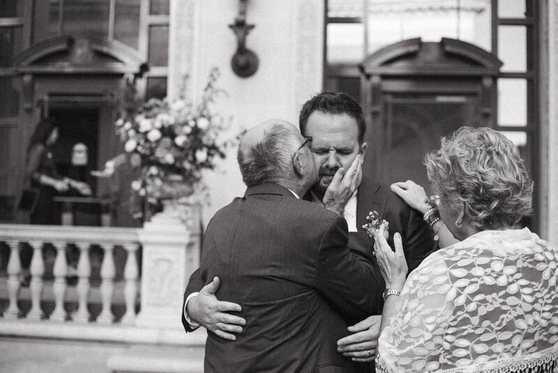 Groom is emotional as he is embraced by his father on his wedding day in San Francisco